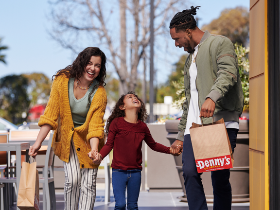 Happy family carrying Denny's takeout